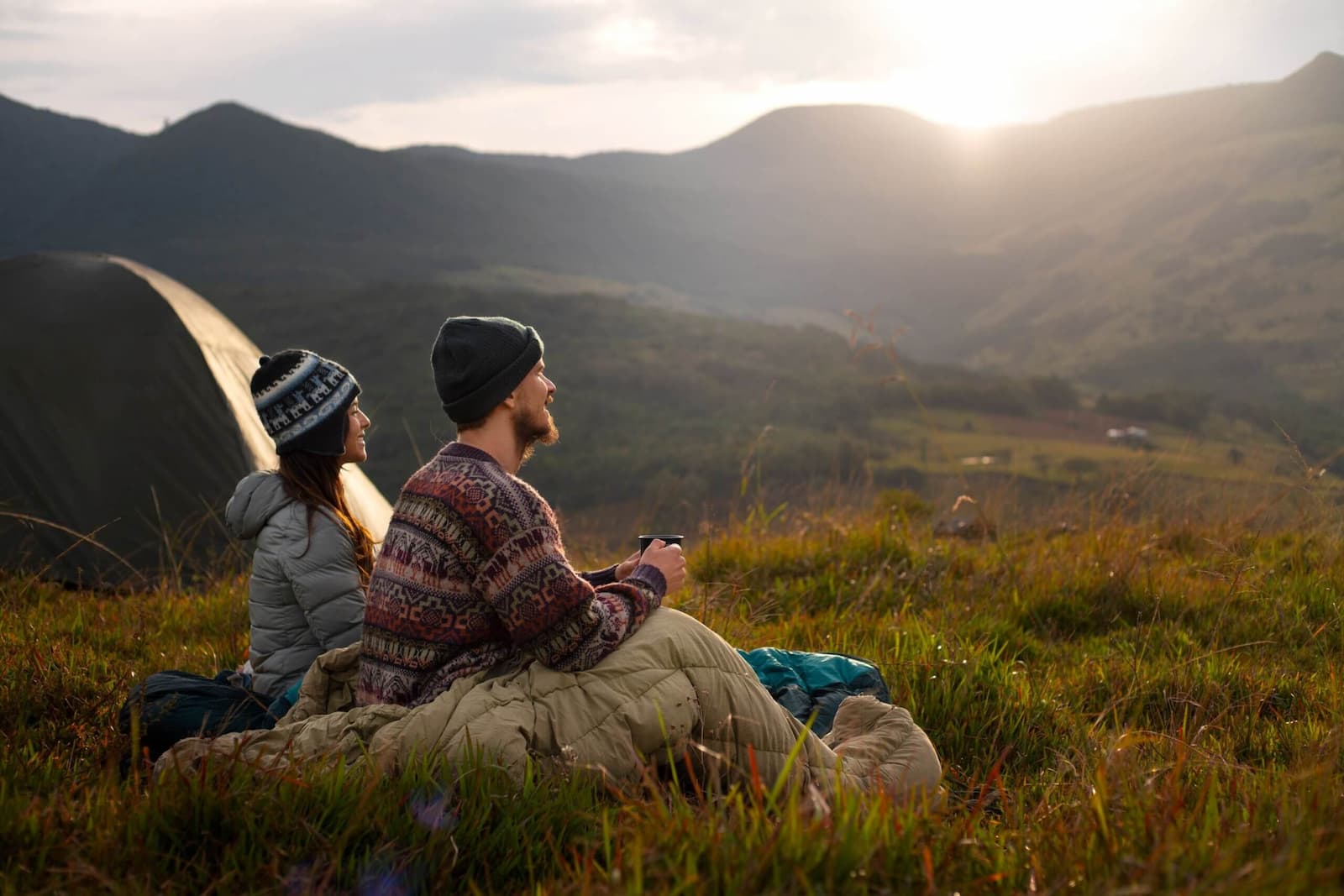 Couple camping in the mountains, symbolising financial freedom and passive income.